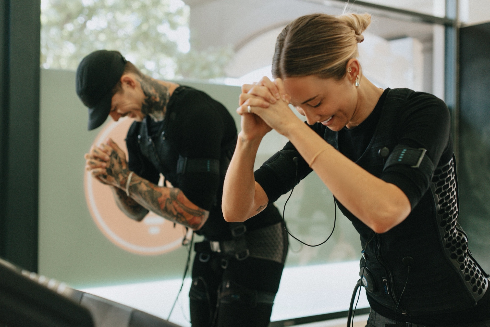 Trainer coaching a client through boxing in a bright studio
