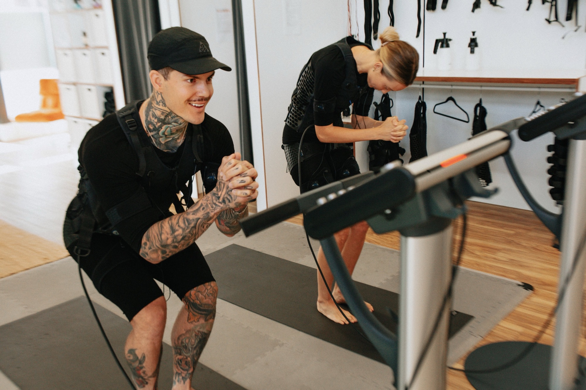 20FIT coach guiding a client through a squat