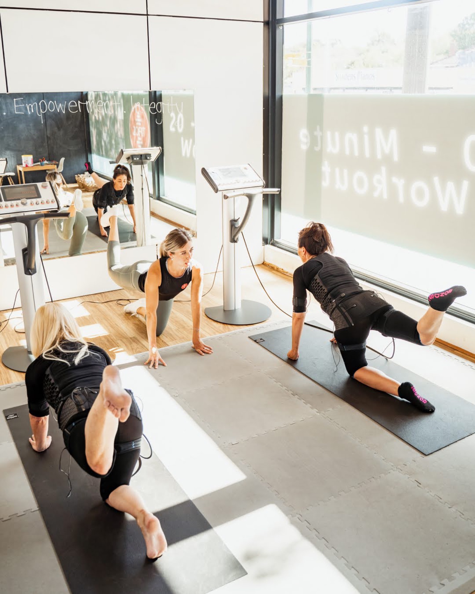 Client training in front of the 20-Minute Workout board