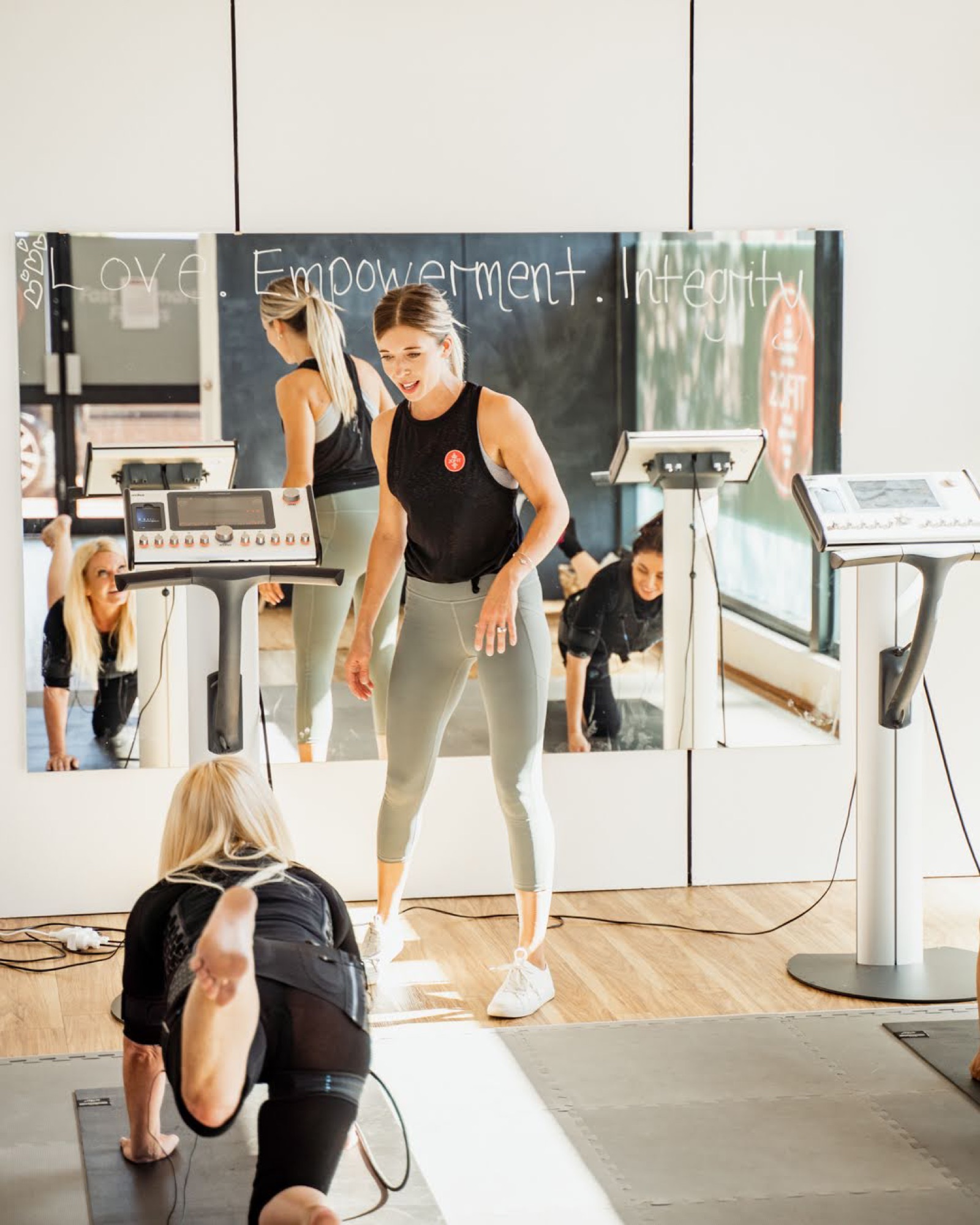 Client stretching in front of the Empowerment board