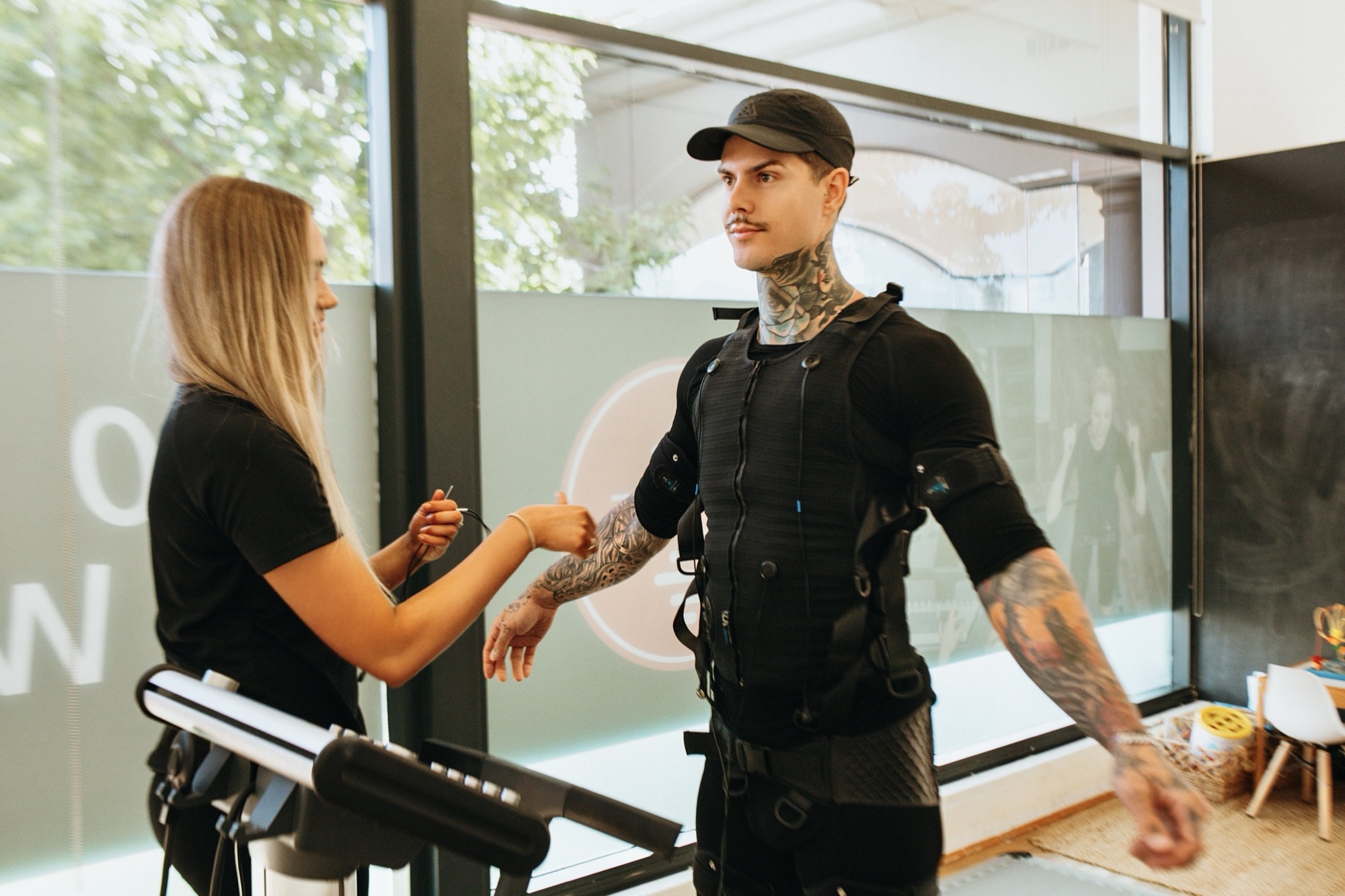 20FIT trainer fitting a client's EMS suit